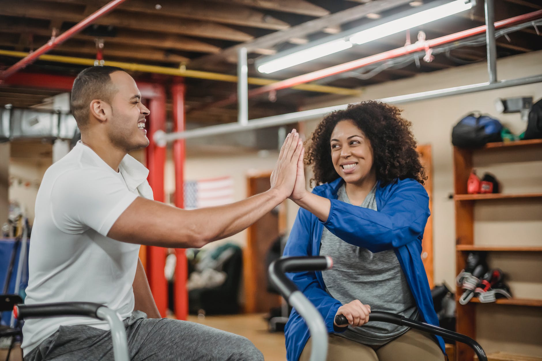 happy multiethnic sportspeople clapping hands in gym
