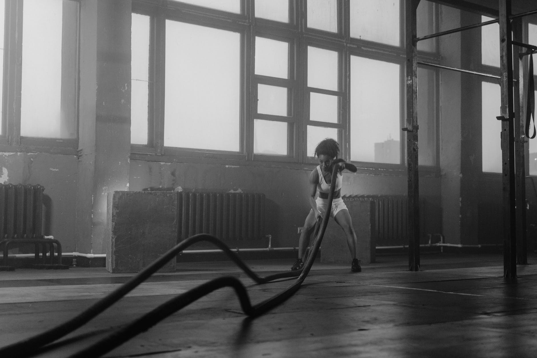 a woman working out with battle ropes
