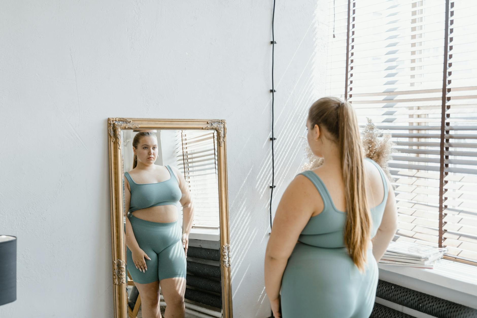 Person looking confidently in the mirror, visualizing a healthier version of themselves.