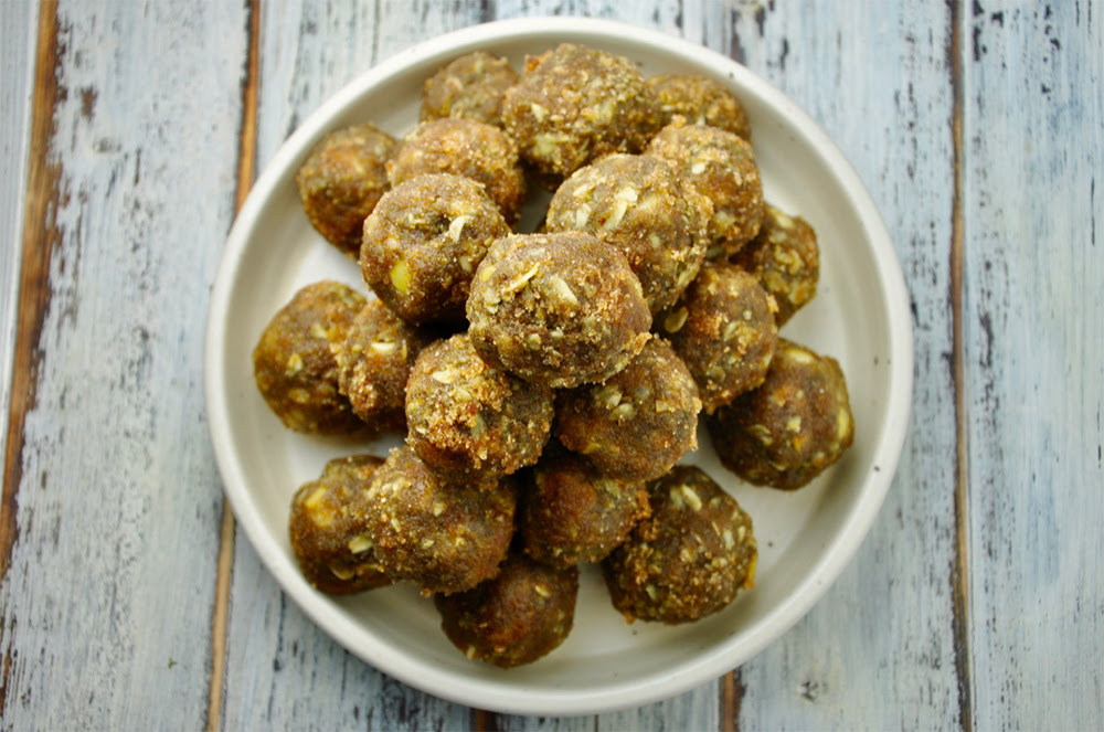 A plate of apple fritter protein balls, rolled in brown Swerve, ready to enjoy as a healthy snack.