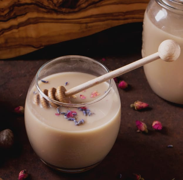 A creamy Hazelnut & Honey Smoothie in a glass, made with roasted hazelnuts, honey, coconut oil, and almond milk – a nutritious Ayurvedic drink for recovery and strength building.