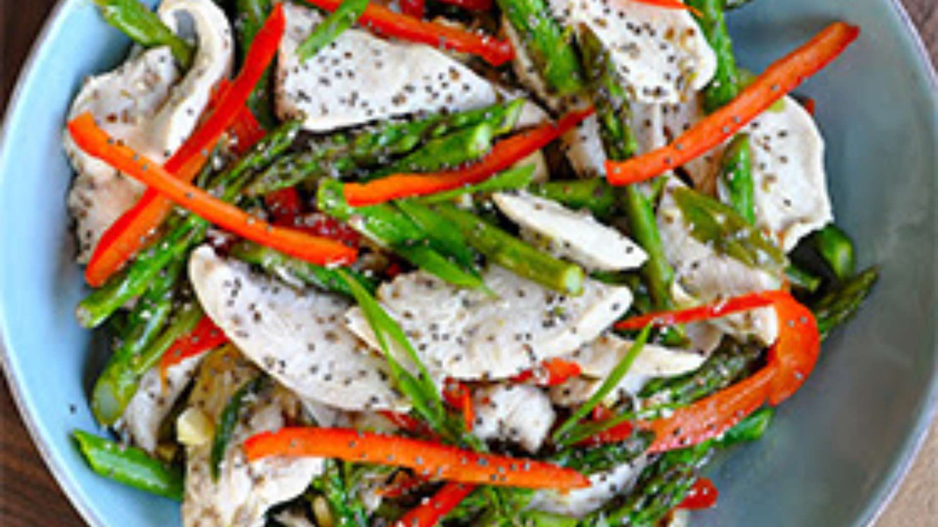 Protein-packed chicken and asparagus stir fry in a skillet