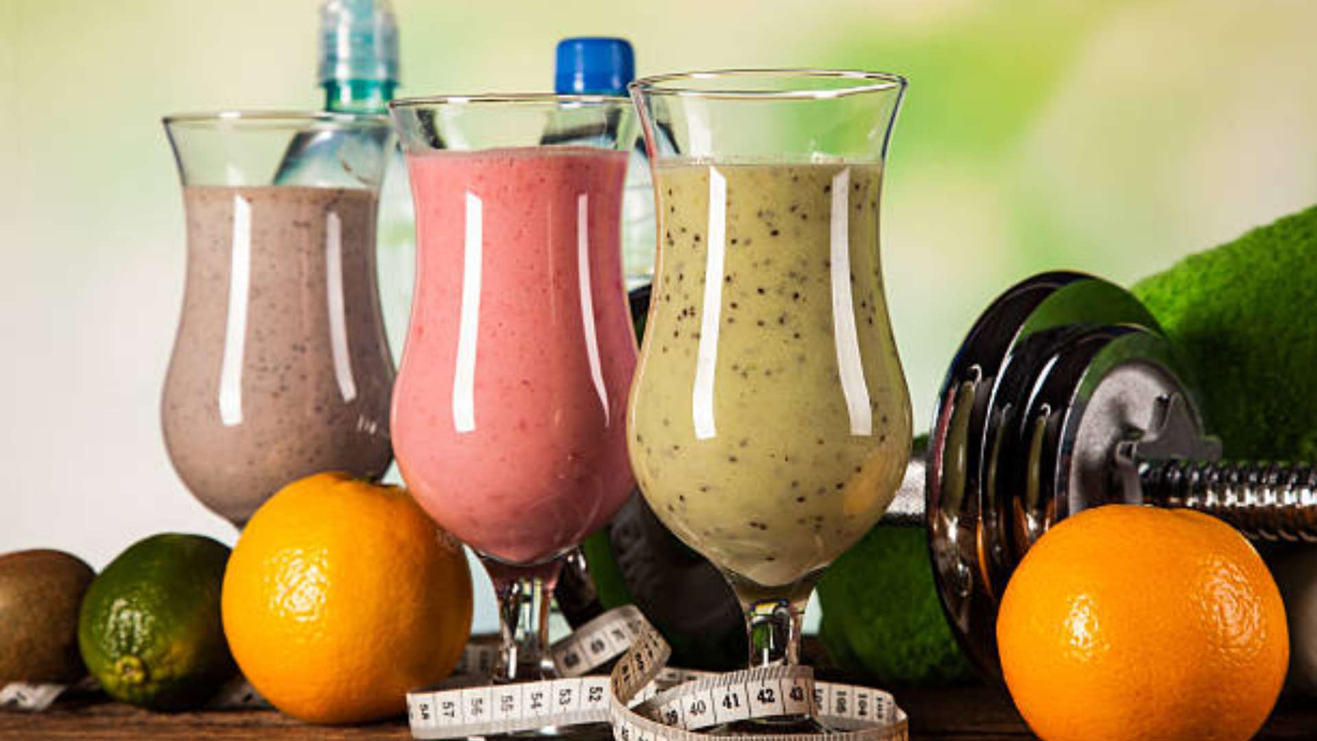 Glass of a protein shake surrounded by healthy ingredients prepared by a San Diego Personal Trainer.