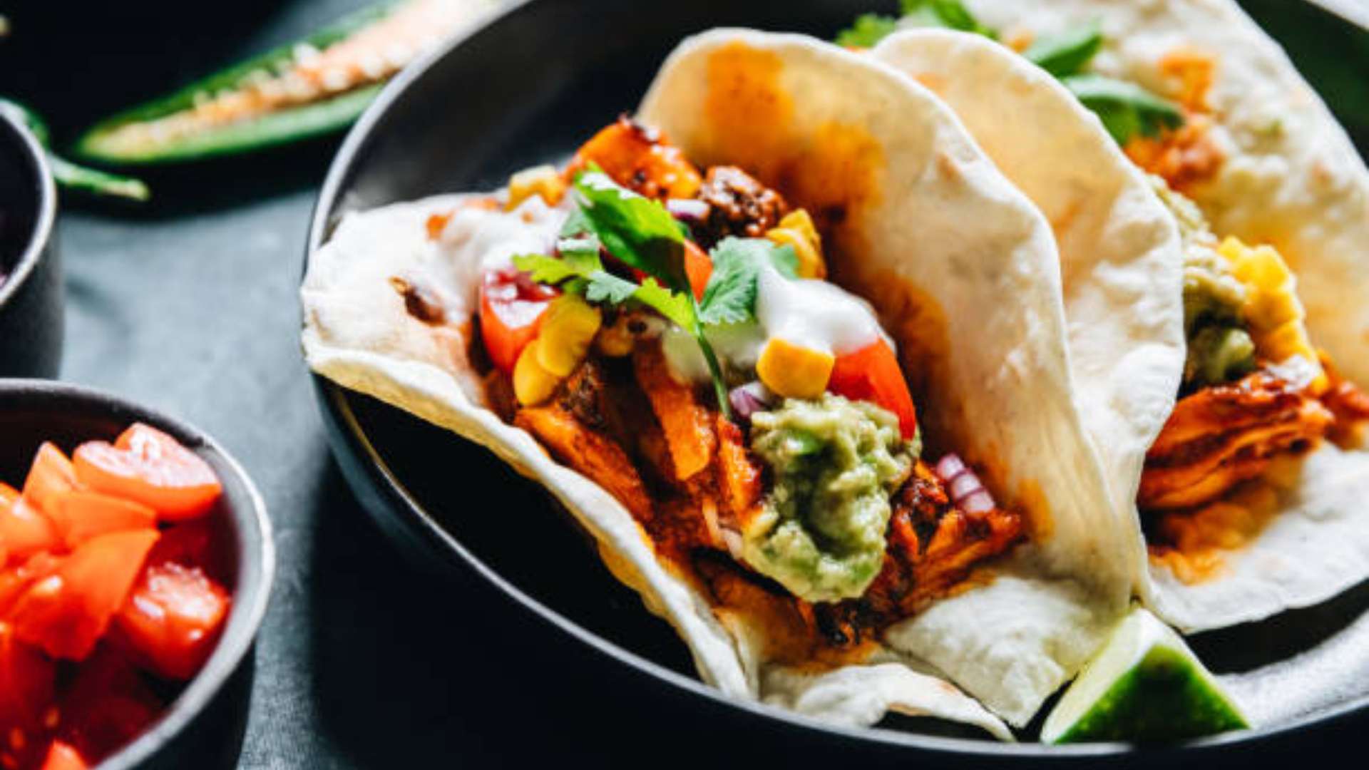 Smoky BBQ tofu burrito bowl with rice, black beans, corn, salsa, and creamy drizzle in a bowl.