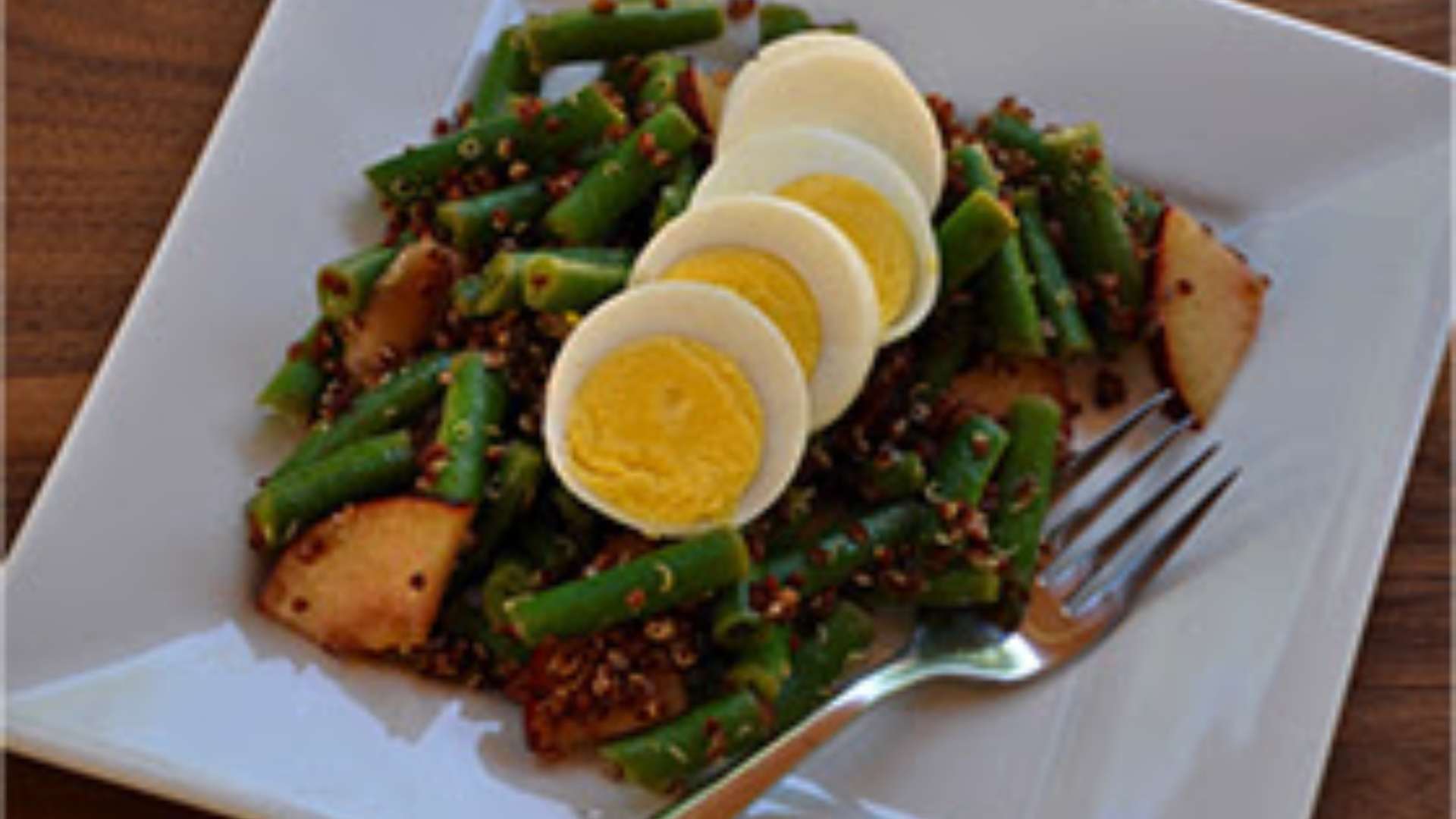 Healthy Green Bean, Egg, and Quinoa Salad in a bowl with fresh ingredients.