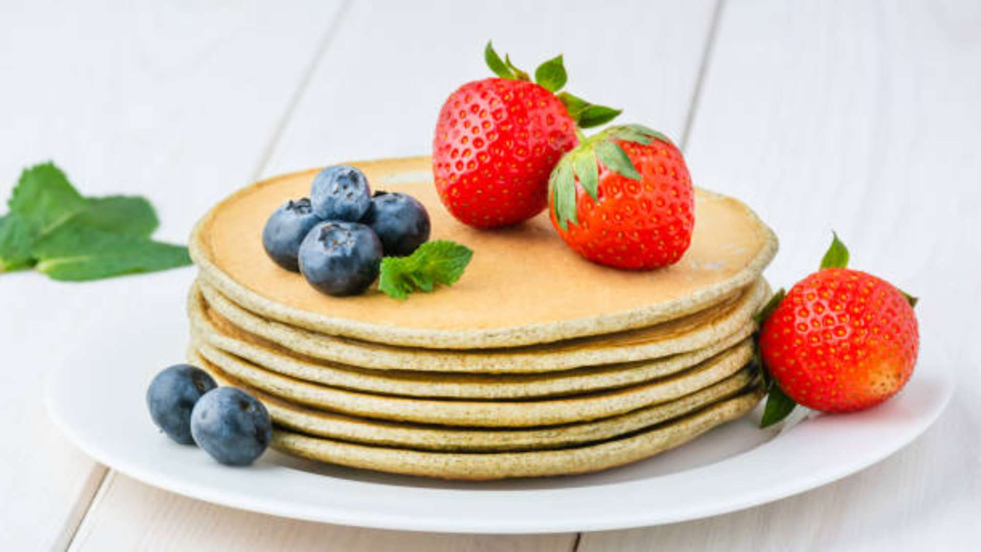 Flax meal protein pancakes stacked with banana slices for a healthy breakfast.