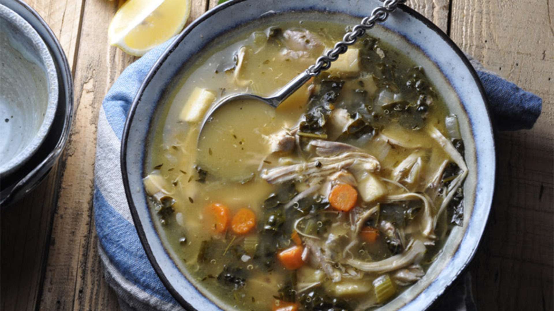 Slow Cooker Turkey and Kale Soup in a bowl, garnished with fresh herbs