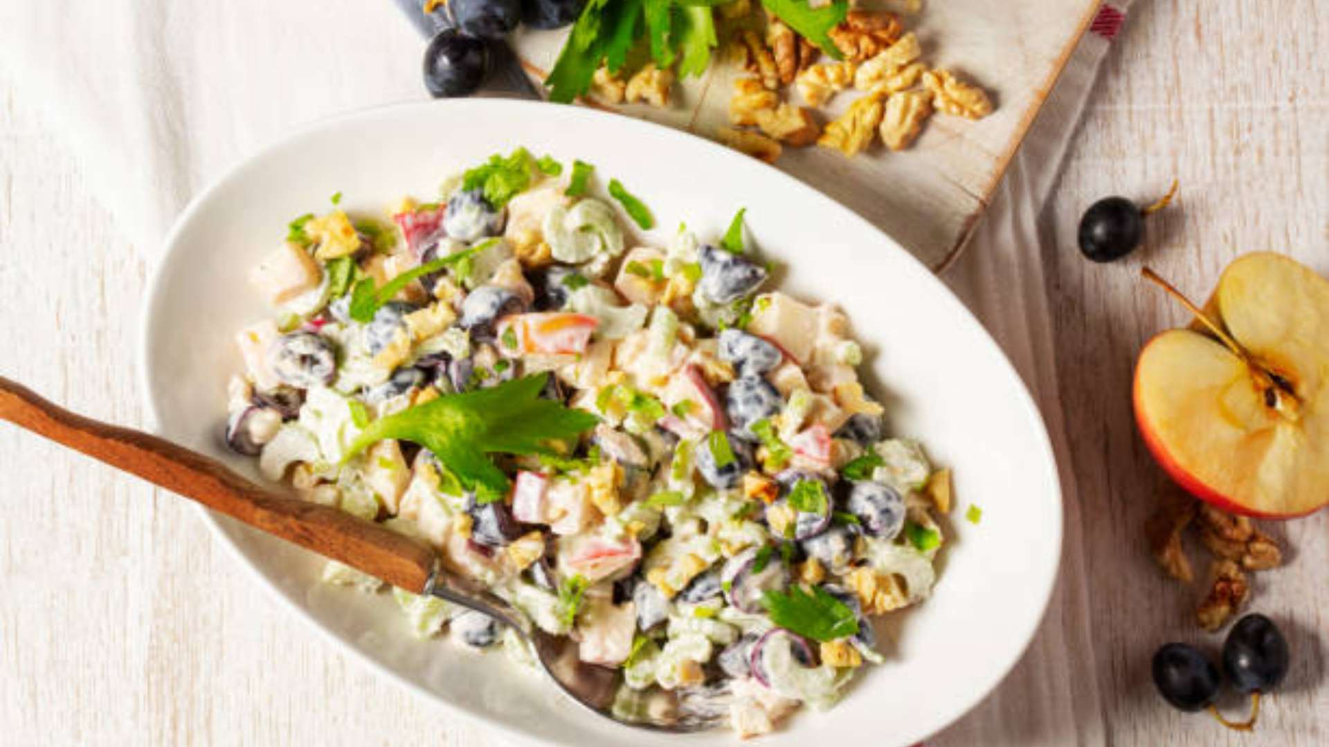 Creamy apple celery salad with protein, served in a bowl.
