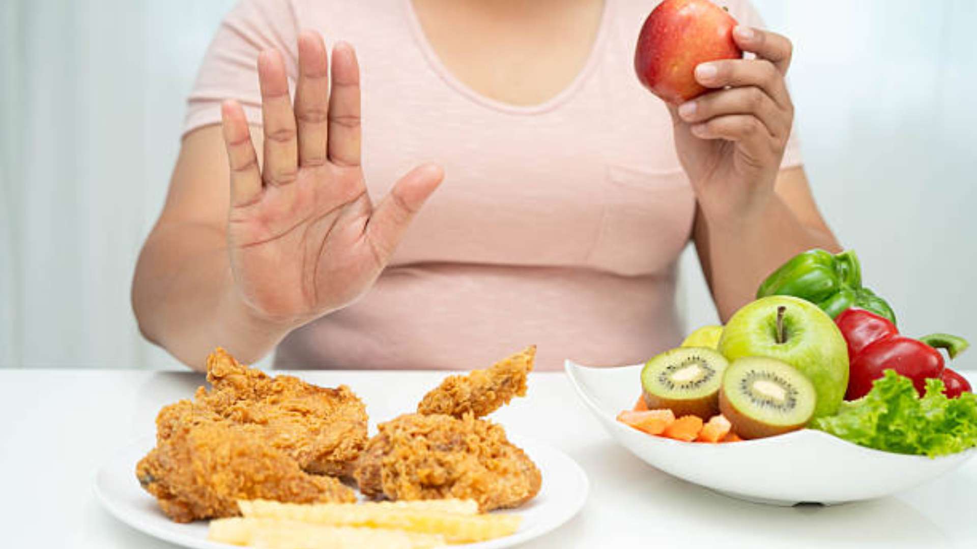 Image of healthy foods like fruits and vegetables promoting a balanced diet to break food cravings.