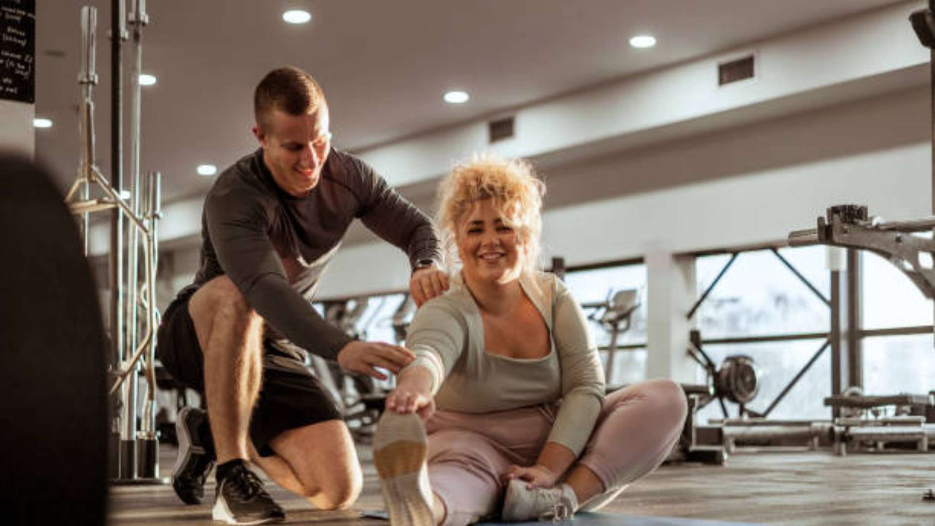San Diego personal trainer helping a client with fitness progress.